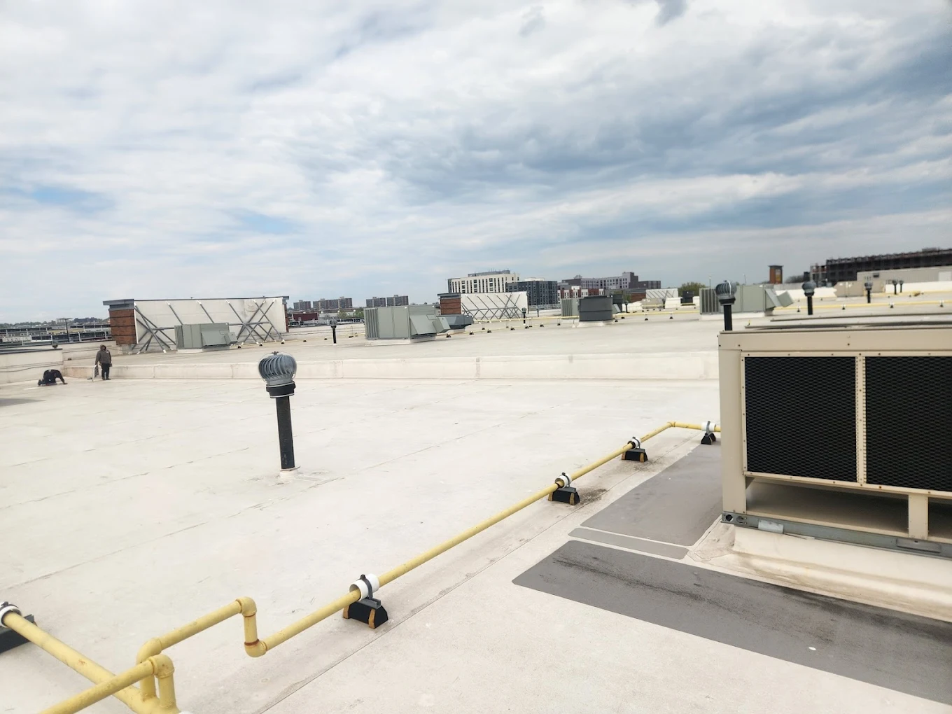 EPDM roof installation Long Island — rubber roofing membrane being laid on a commercial flat roof in Amity Harbor NY