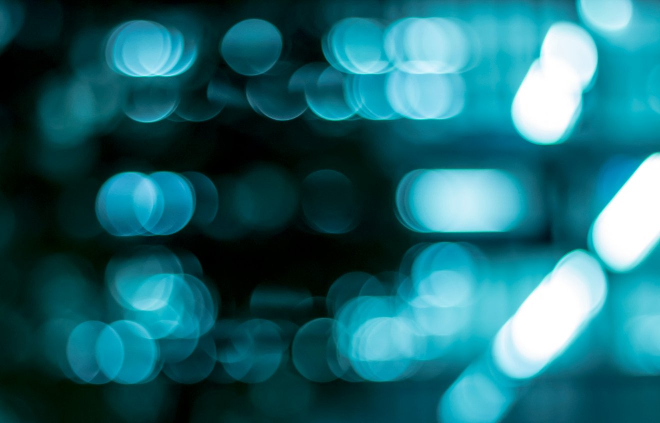 Long streaks of coloured light drawn across a dark surface in a slow exposure