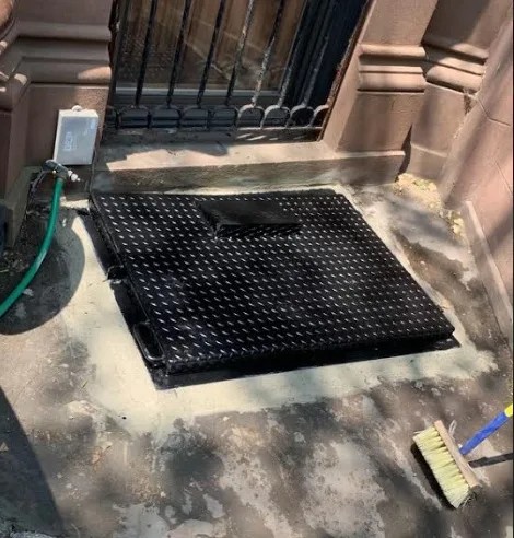 Iron works installation in East New York Brooklyn — steel rolldown gate on commercial storefront